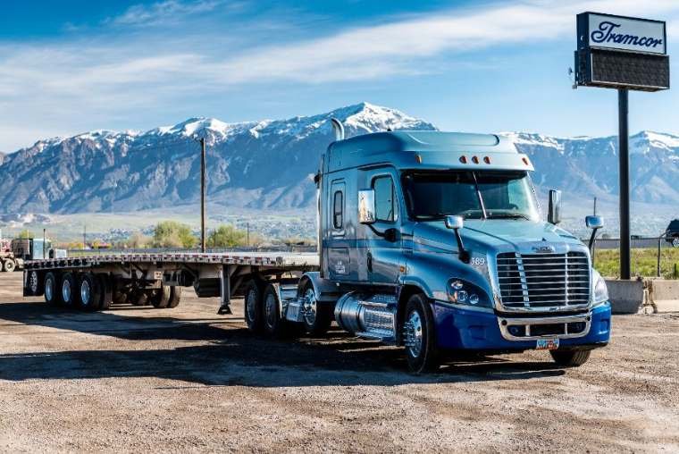 Flatbed semi truck with step-deck trailer